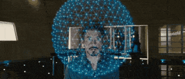 Tony Stark working with a glowing holographic interface, the way Jarvis presents information in Iron Man